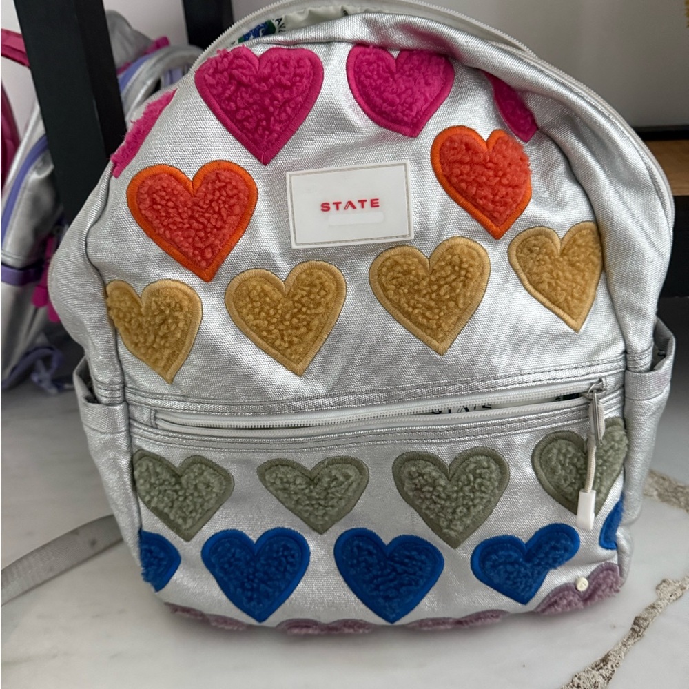 STATE Silver Backpack with Rainbow Heart Print
